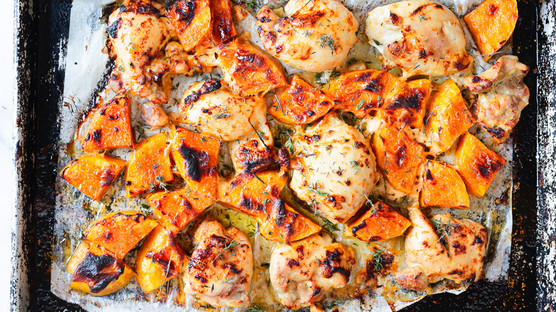 A tray of caramelized maple-glazed chicken thighs and butternut squash without the yogurt sauce