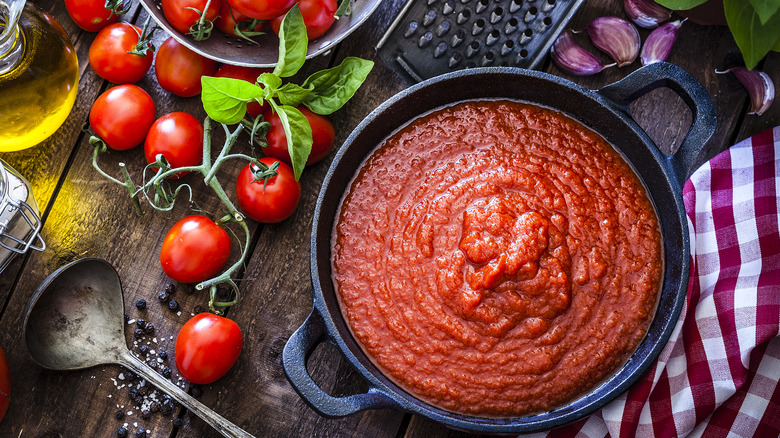 skillet of tomato sauce and ingredients