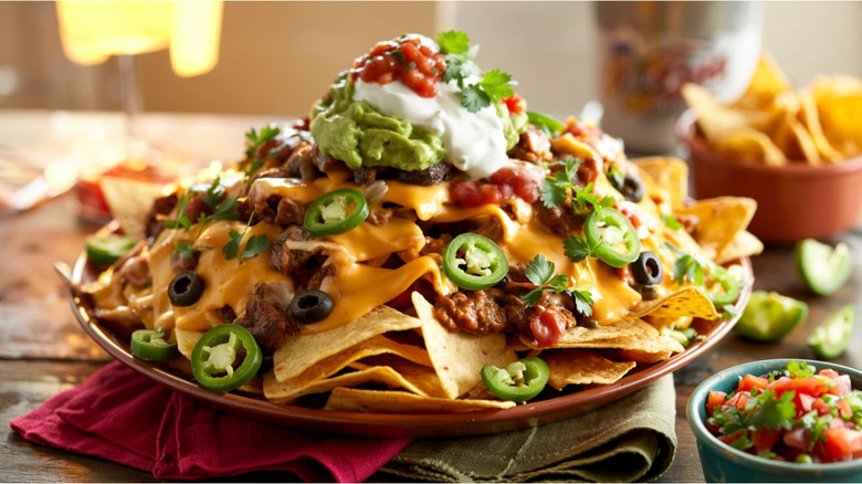 plate of loaded nachos with sour cream