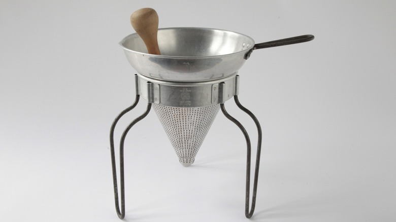 A chinois strainer with a stand