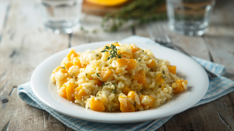 Plate of squash and thyme risotto laid on table