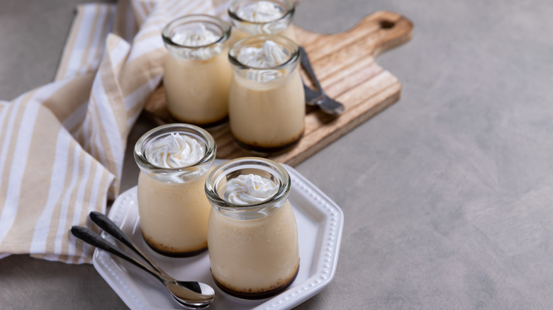 Jars of pudding with whipped cream