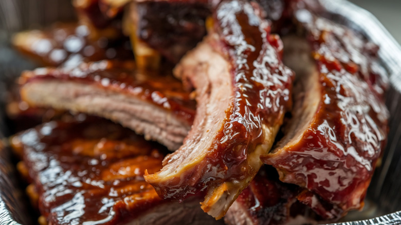 Close up of baby back ribs with sauce sliced off the rack