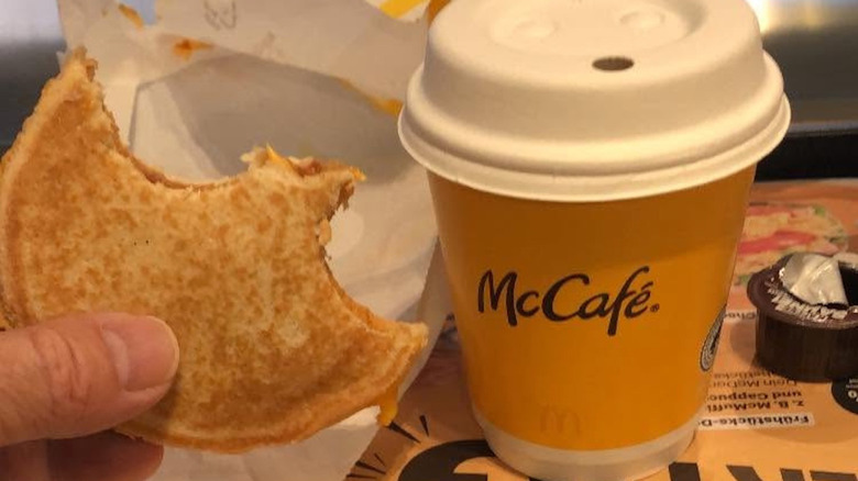 A half-eaten McToast and coffee from McDonald's