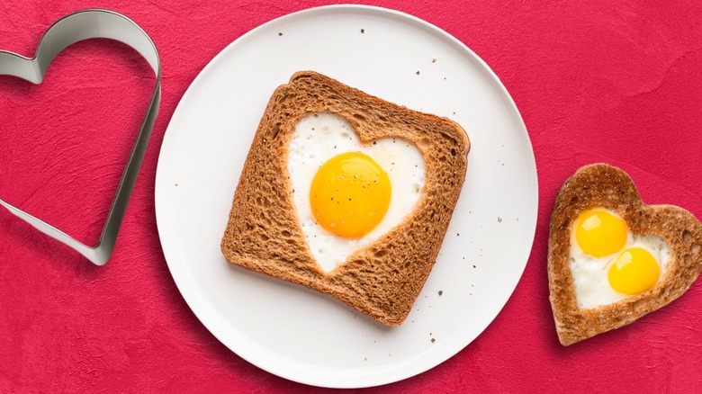 Top-down view of heart-shaped egg-in-a-hole toast