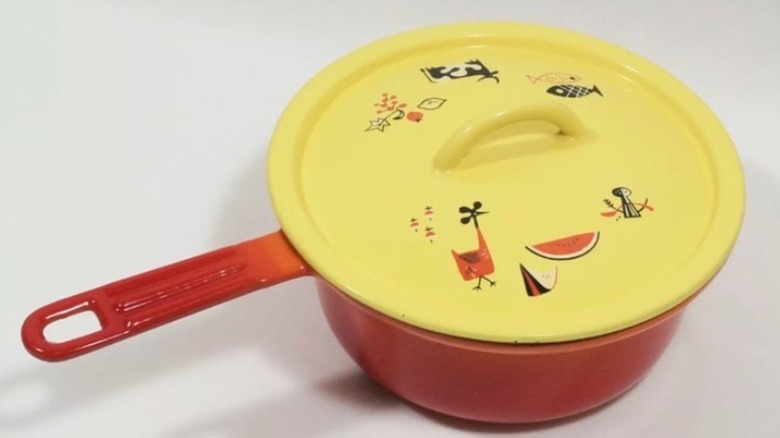 Orange Descoware pot with animal-patterned lid