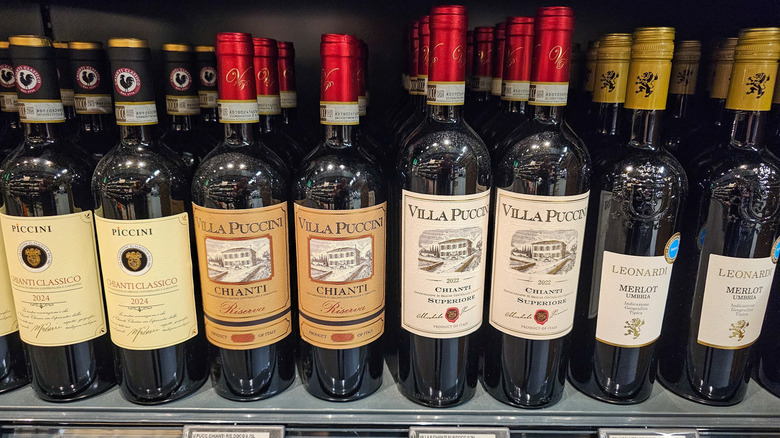Various bottles of wine on a store shelf.