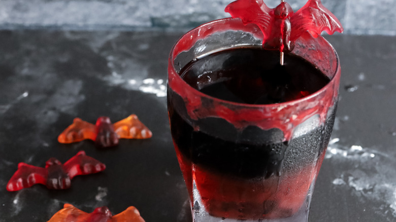 vampire's kiss cocktail garnished with gummy bat