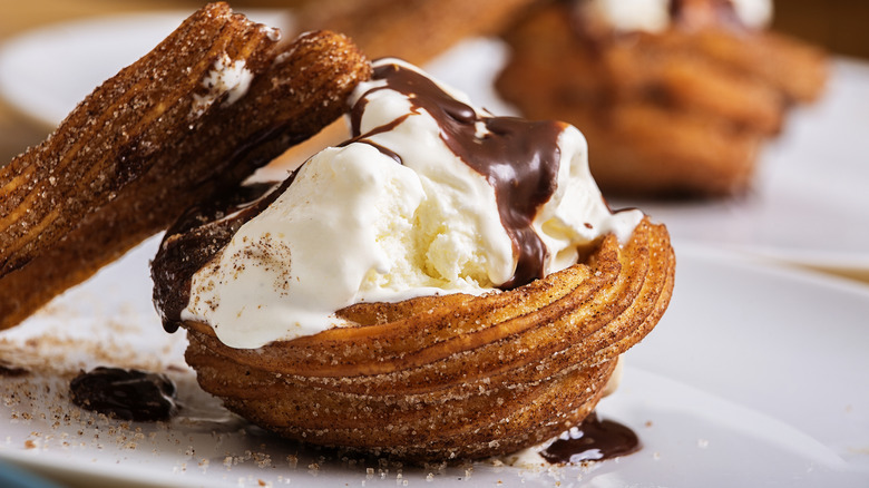 a churro cup with vanilla ice cream in it