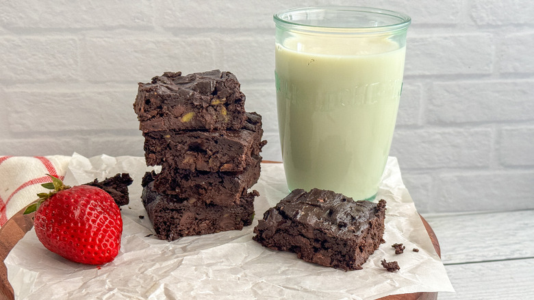 vegan brownies stacked with glass of milk
