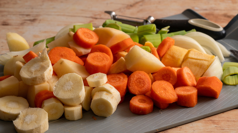 Vegetables all cut up and sprawled on a cutting board