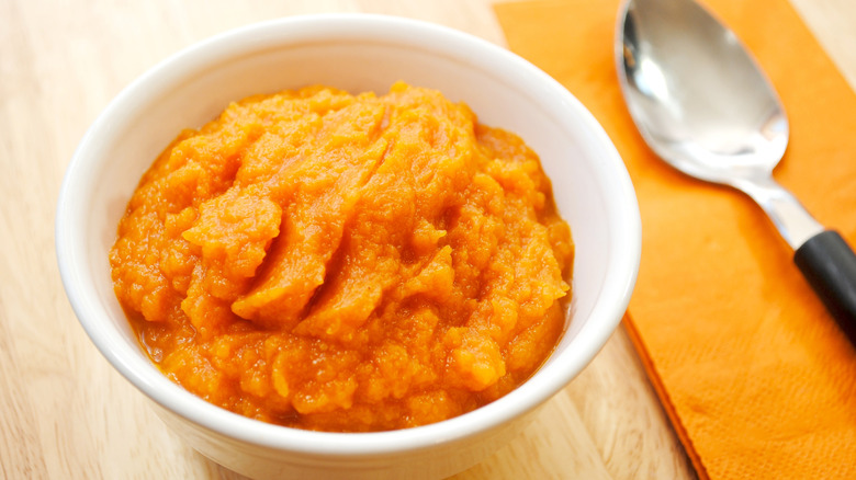 Bowl of mashed butternut squash with a spoon