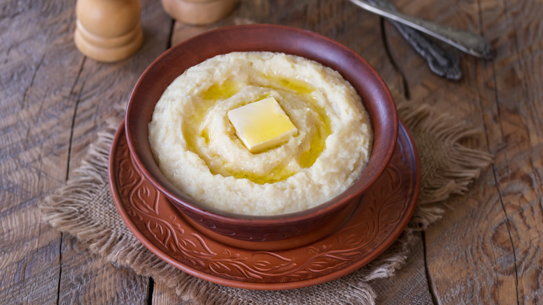 Mashed celeriac root in a bowl topped with butter