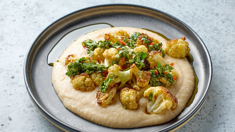 Pureed vegetable mash under roasted cauliflower