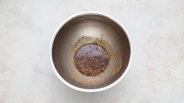 brown marinade in metal bowl
