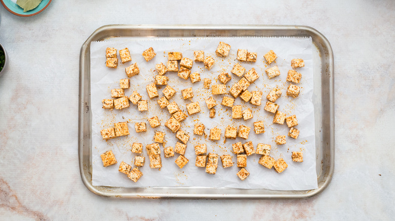 cubed tofu on baking sheet
