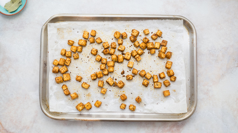 cubed tofu on baking sheet