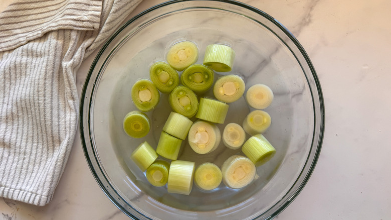 leeks in bowl of water