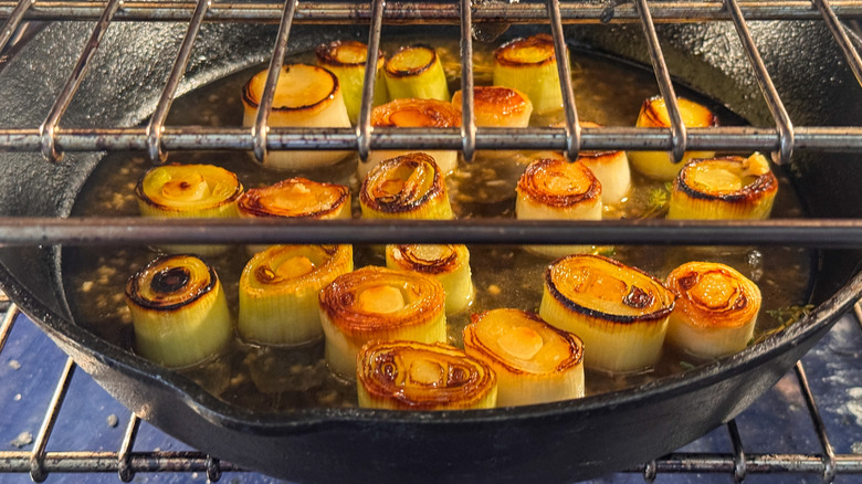 skillet with leeks in oven