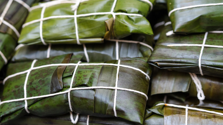 Pile of traditional Venezuelan hallacas (steamed corn dough wrapped in corn leaves)