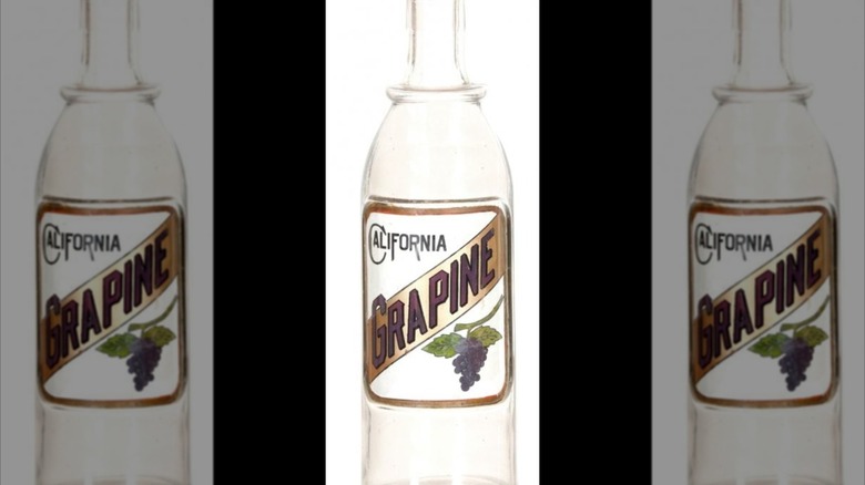 Mirrored image of California Grapine Syrup Bottle against white background