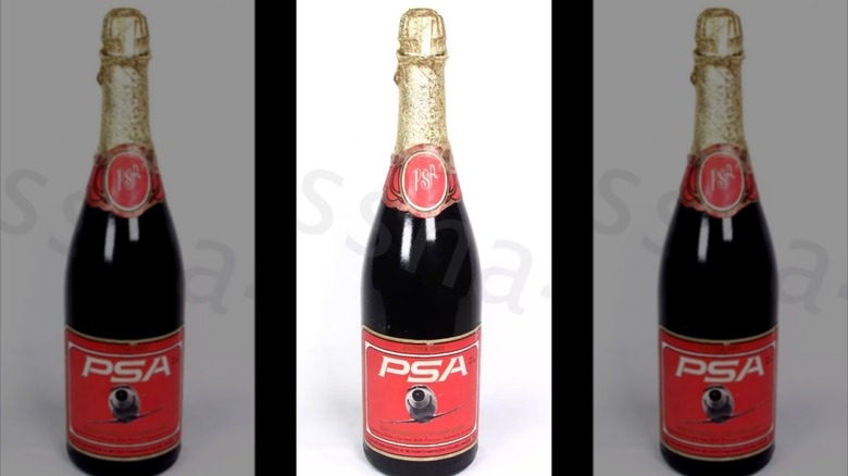 mirrored image of Pacific Southwest Airlines Champagne Bottle against white background