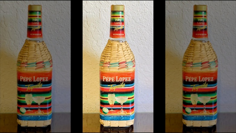 Mirrored image of Pepe Lopez Tequila Bottle against white wall