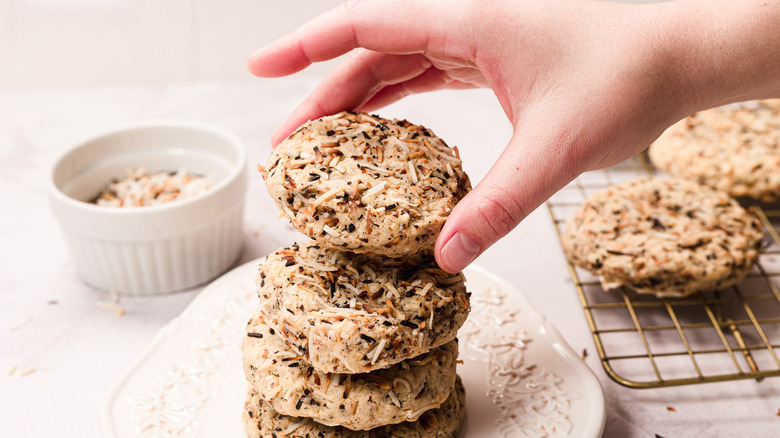 Hand picking up cookie from stack