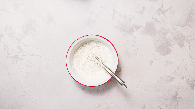 Dry ingredients in bowl with whisk