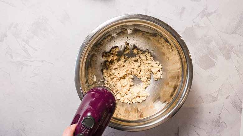 Mixing butter and sugar with beaters