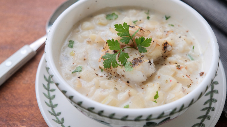 Close-up of a patterned bowl of Cullen skink on a wooden table