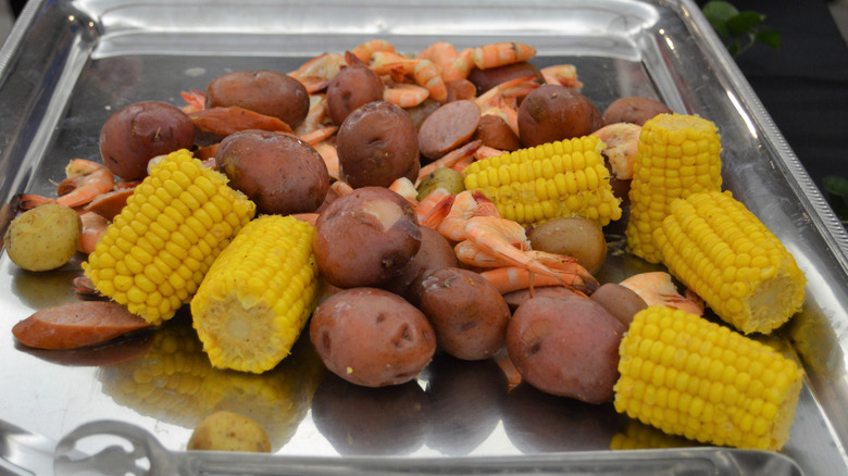 Lowcountry boil (potatoes, sausages, corn, and shrimp) in a metal dish