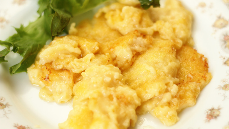 Corn mush fritters on a patterned plate with lettuce