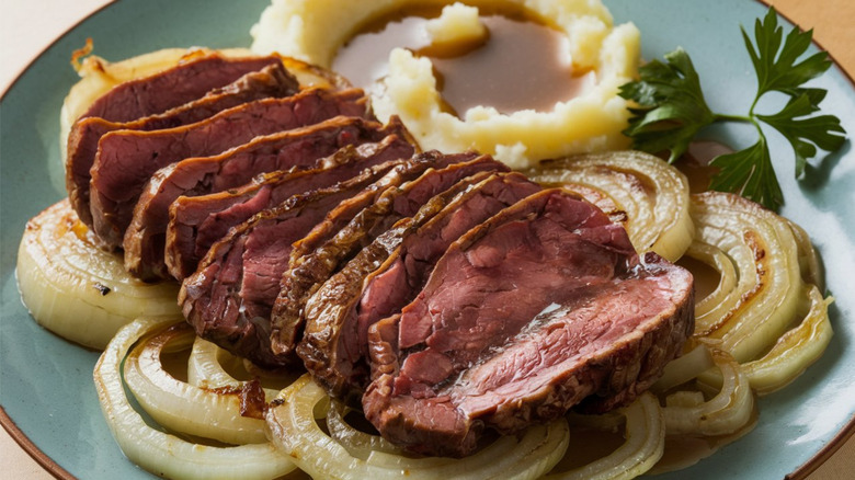 Pan-fried calf's liver with caramelized onions on a blue plate