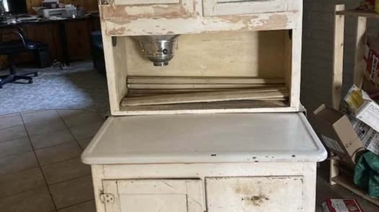 An old kitchen cabinet with a built-in flour sifter