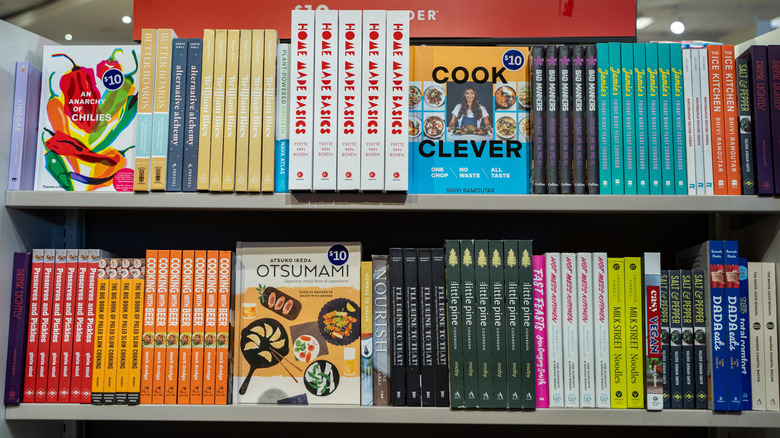 Cookbook section of a bookstore, displaying many colorful cookbooks on the shelves.