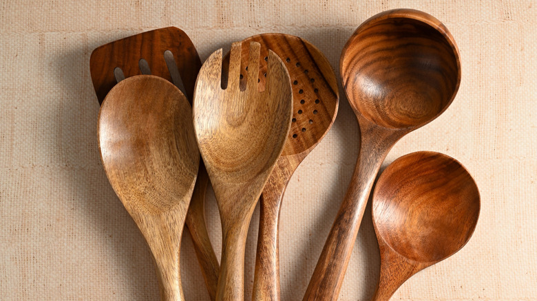 A selection of six wooden cooking utensils.