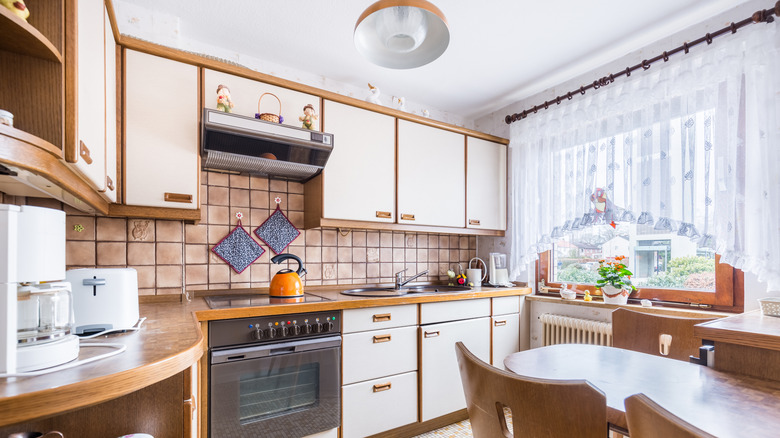 a vintage kitchen with wood accents and a large window
