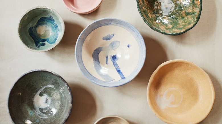 An assortment of vintage, painted bowls on a table
