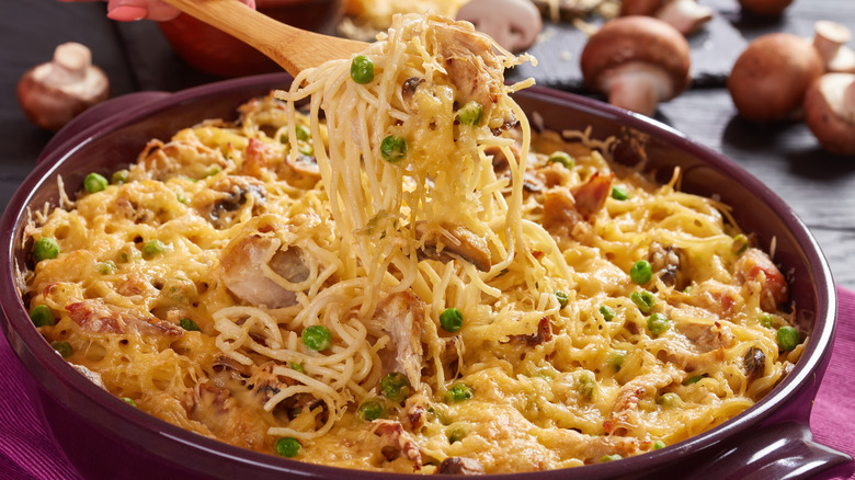 a spoon pulling up turkey tetrazzini out of a pot