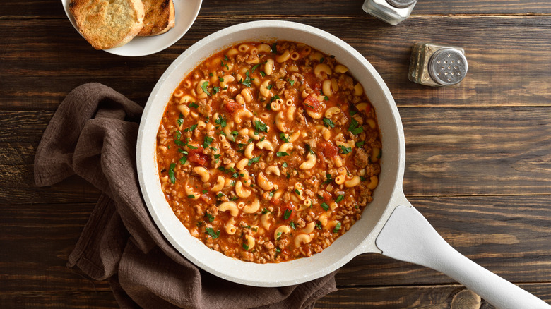 Goulash with elbow macaroni and ground beef in cooking pot