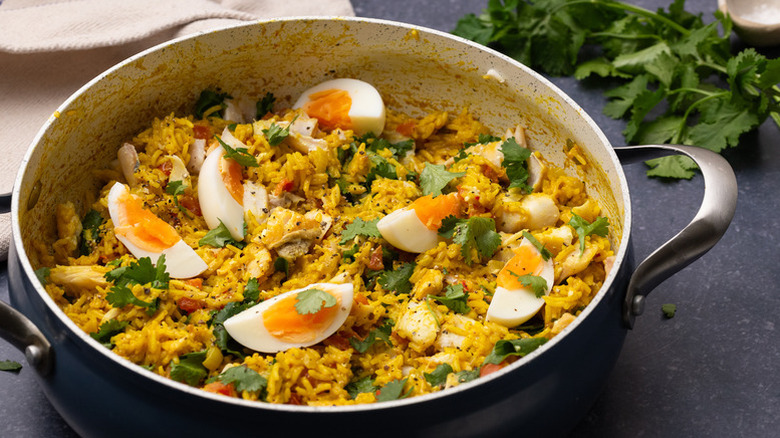 Pot of kedgeree with smoked fish and hard-boiled egg slices
