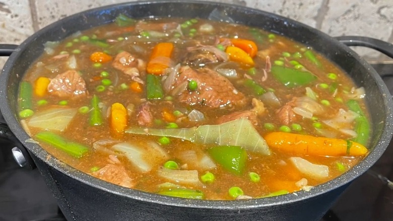 Mulligan stew with meat and veggies in large cooking pot