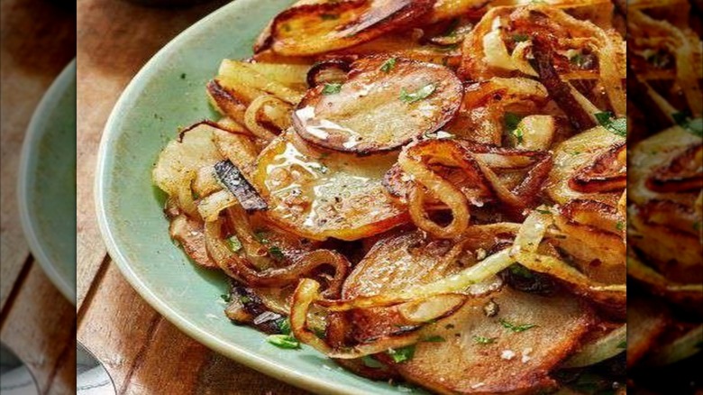 Lyonnaise potatoes on a green dish