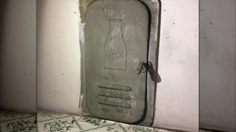 A milk door on the side of the kitchen wall