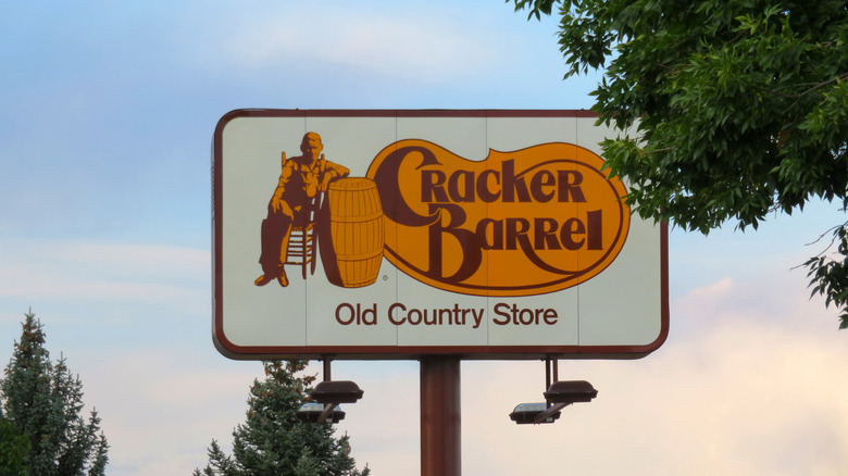 Cracker Barrel sign against colorful sky