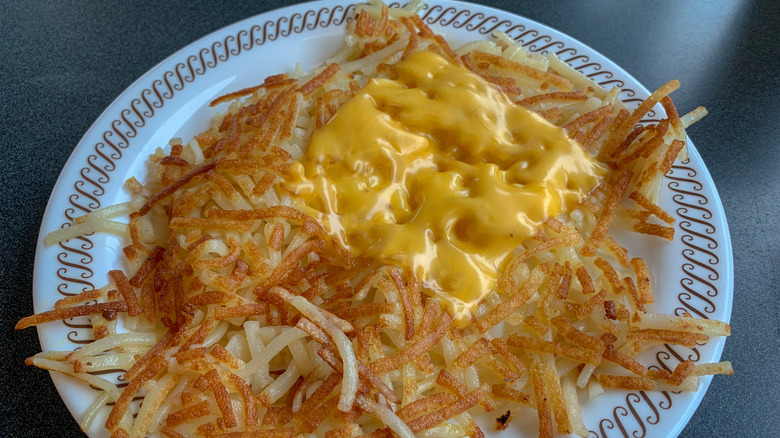 Waffle House hash browns with melted cheese on white plate