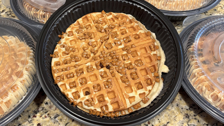 Large waffle in a plastic package, covered with partially melted peanut butter chips