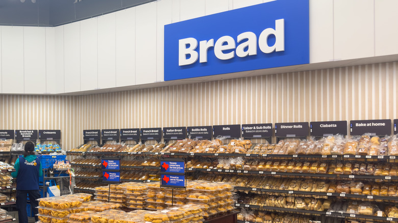 Walmart bread section with employee stocking items