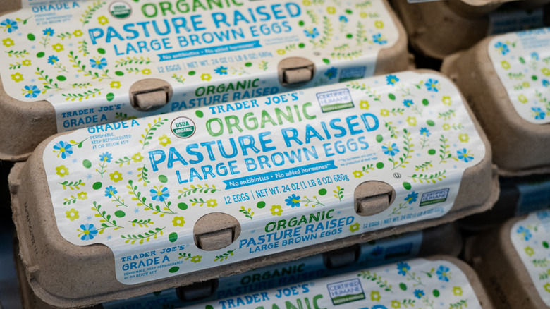Cartons of Trader Joe's organic, pasture-raised eggs in a store display